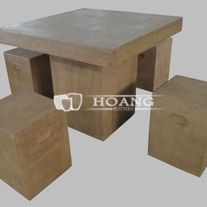 Light brown cement tables and chairs